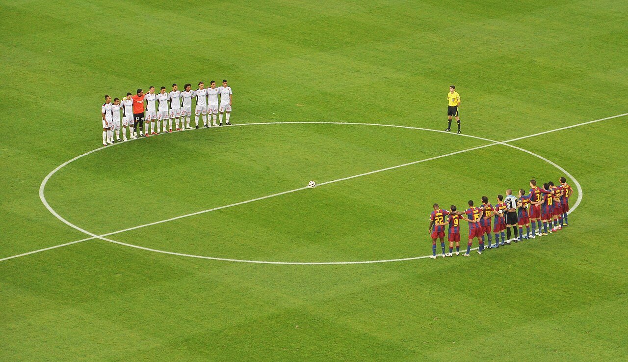 Two giants line up before kickoff — the ritual of a Clásico night.